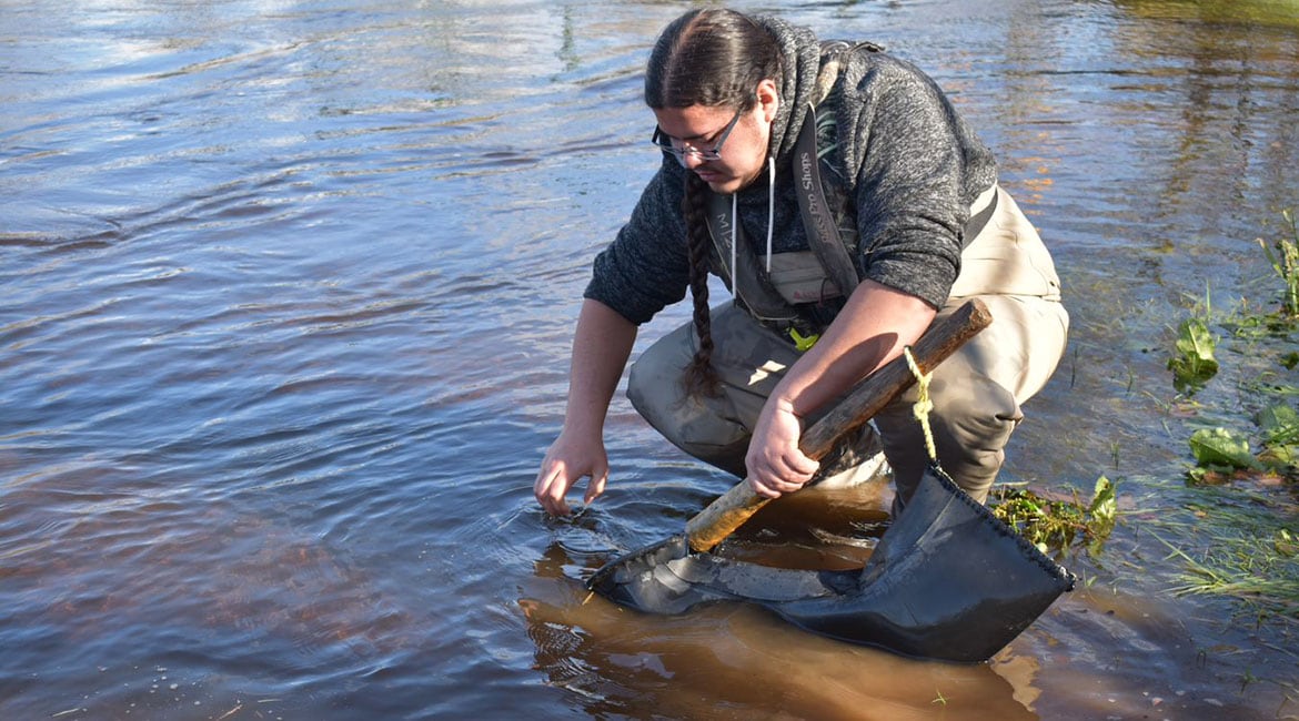 photo of indigenous man fishing