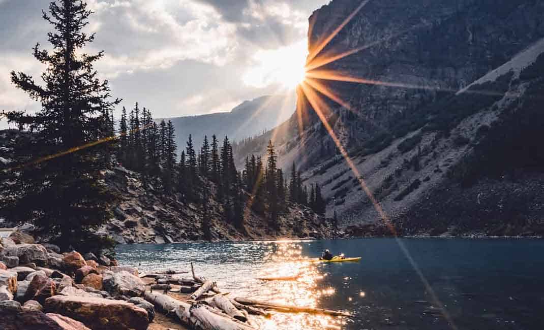 photo of sun burst over mountain
