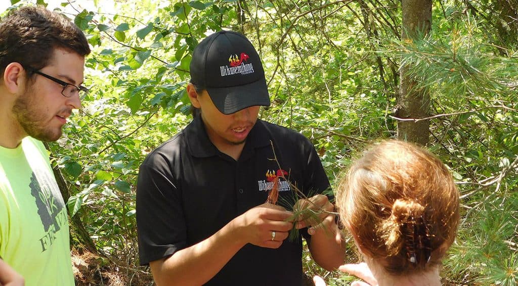 photo of indigenous youth conversing with a young man and woman