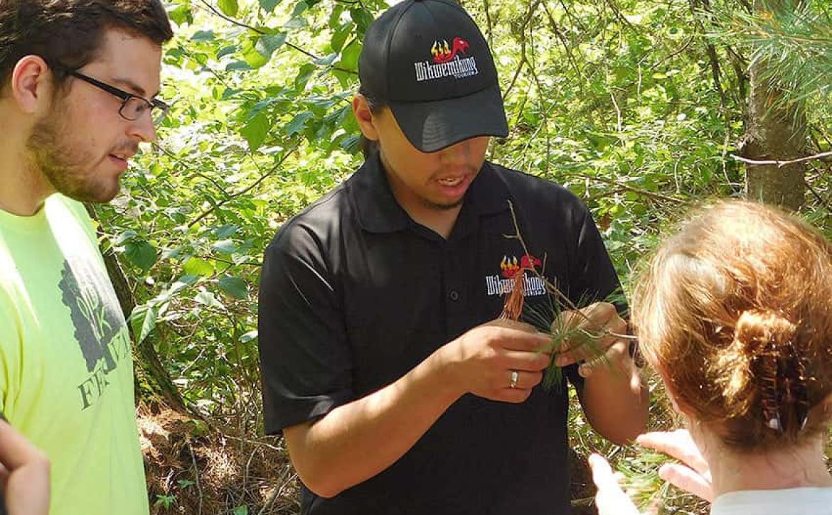 photo of indigenous youth conversing with a young man and woman