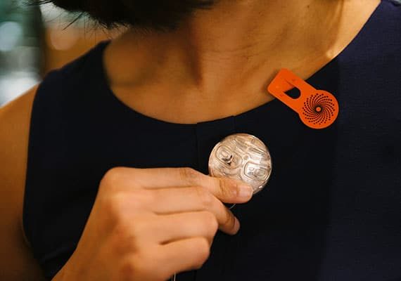 close-cropped photo of woman wearing silver broach