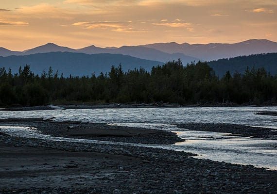 photo of scenic waterway at sunset
